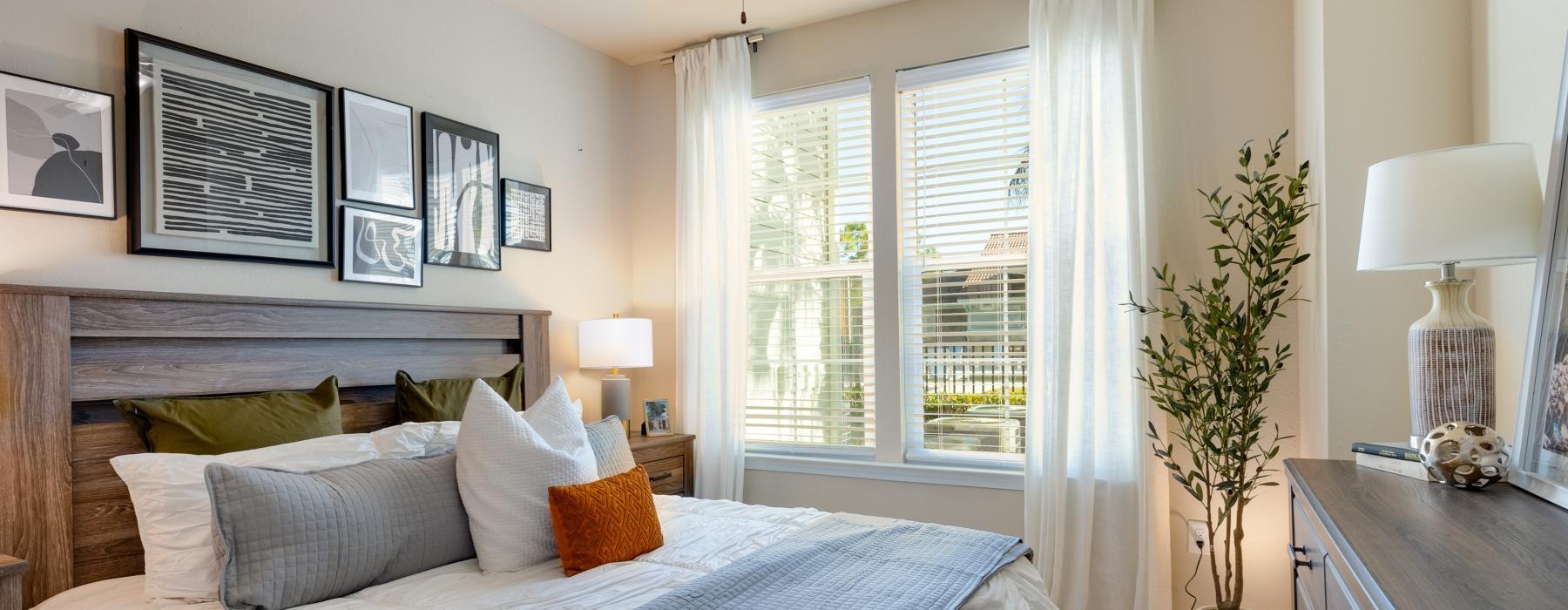 a bedroom with a fan and a bed