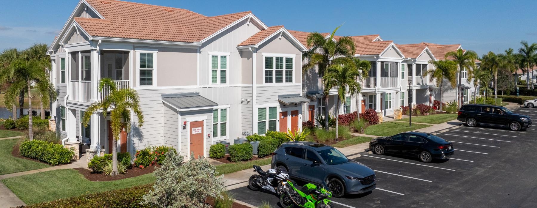 a motorcycle parked in front of a white house