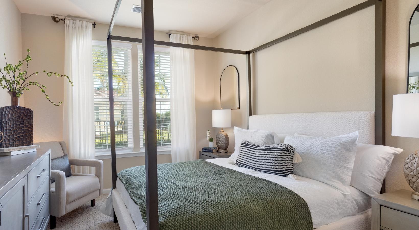 a bedroom with a bed and a chair