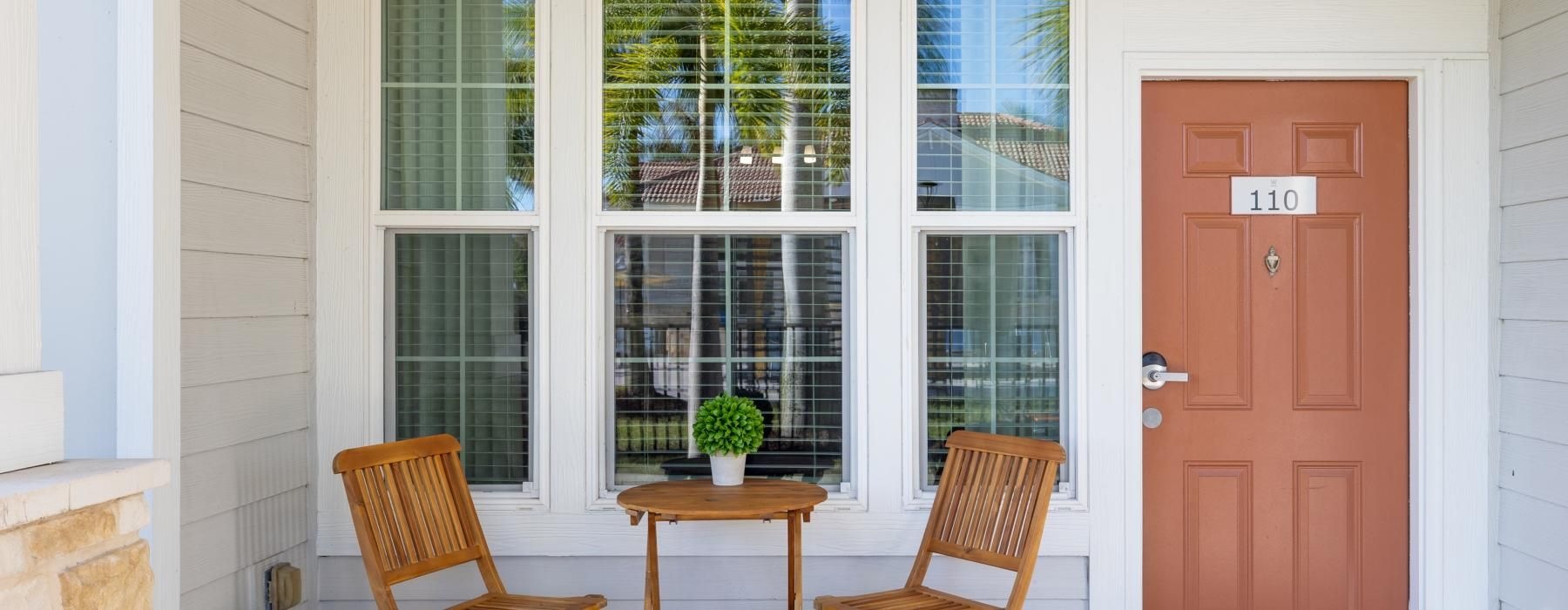 a room with a table chairs and a door with a window