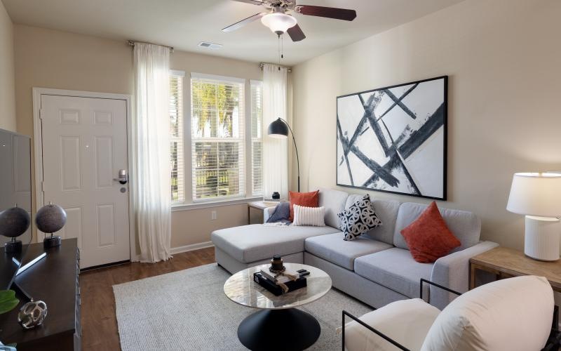 a living room with a fan and couches