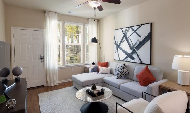 a living room with a fan and couches